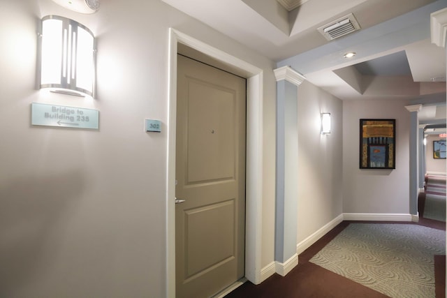 hallway featuring a raised ceiling