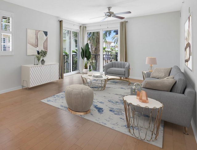 living room featuring ceiling fan and light hardwood / wood-style flooring