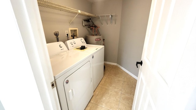 clothes washing area with water heater and washer and clothes dryer