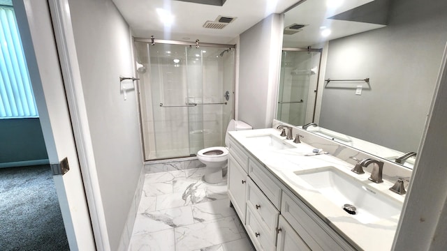 bathroom featuring vanity, toilet, and a shower with shower door