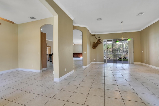 empty room with ceiling fan, crown molding, and light tile patterned flooring