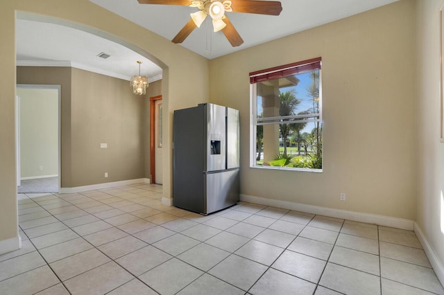 kitchen with pendant lighting, ceiling fan with notable chandelier, stainless steel fridge with ice dispenser, and light tile patterned floors