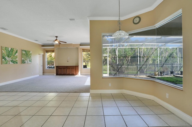 tiled spare room with crown molding and ceiling fan