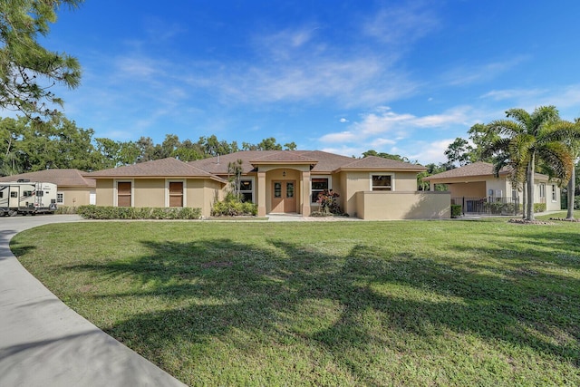 mediterranean / spanish house with a front lawn