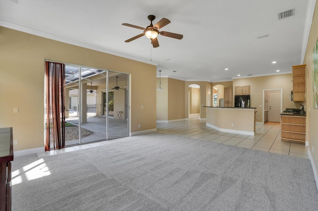 unfurnished living room featuring ceiling fan, ornamental molding, and light carpet