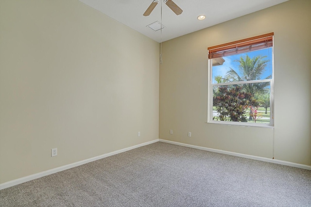 carpeted spare room with ceiling fan