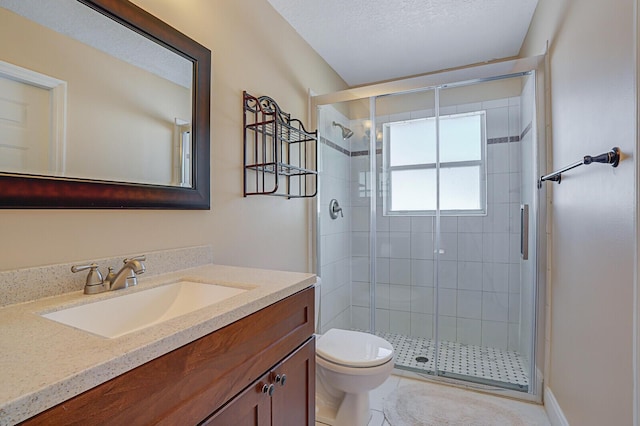 bathroom featuring vanity, a shower with door, tile patterned flooring, toilet, and a textured ceiling