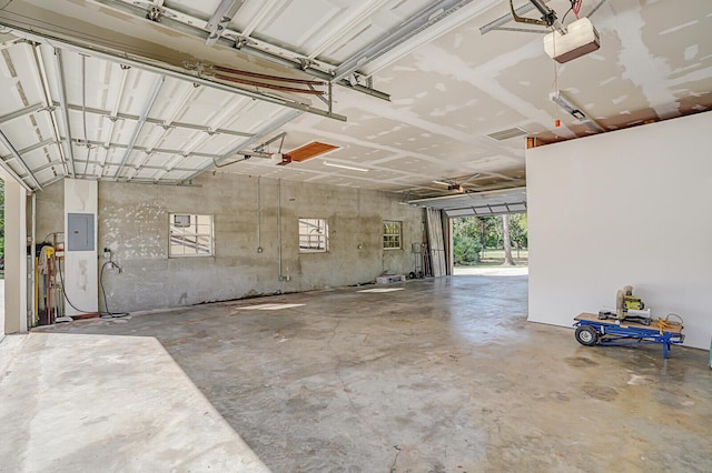 garage with electric panel and a garage door opener