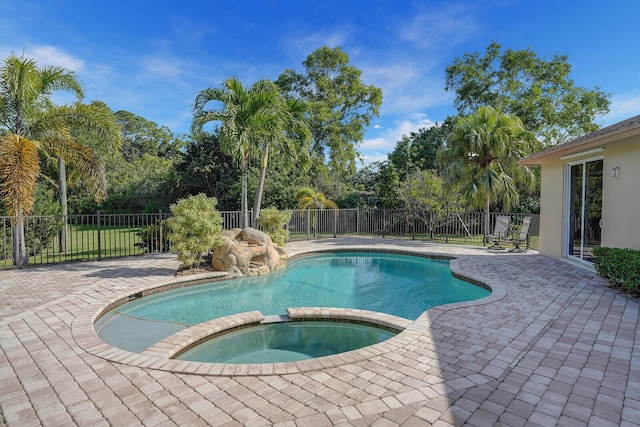 view of swimming pool featuring an in ground hot tub and a patio