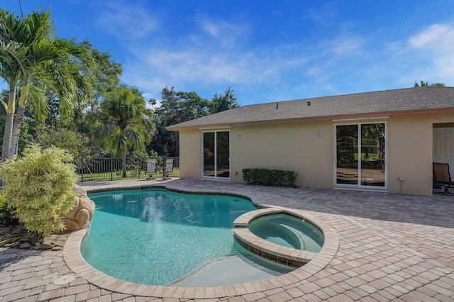 view of pool featuring an in ground hot tub and a patio