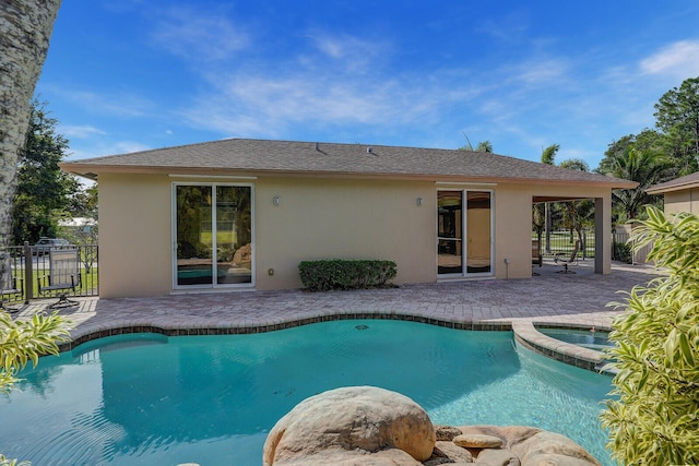 view of swimming pool with an in ground hot tub and a patio