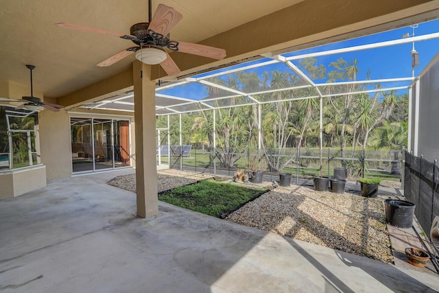 view of patio with glass enclosure and ceiling fan