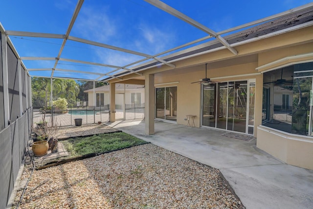 back of property featuring ceiling fan, a lanai, and a patio