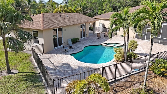 view of swimming pool with an in ground hot tub, a patio, and a sunroom