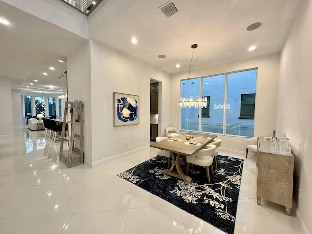 tiled dining space featuring a wealth of natural light and an inviting chandelier