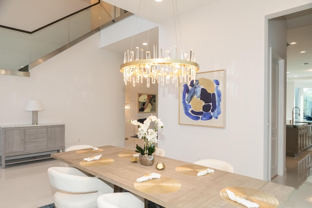 dining room featuring tile patterned floors, a notable chandelier, and sink