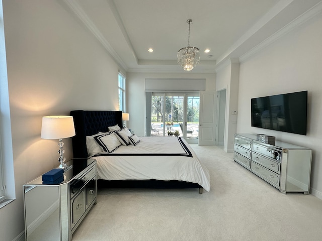 carpeted bedroom featuring access to exterior, an inviting chandelier, a raised ceiling, and ornamental molding