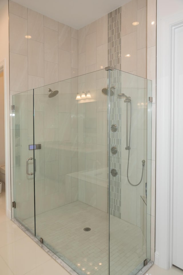 bathroom with a shower with door