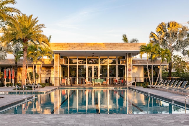 view of swimming pool featuring ceiling fan and a patio