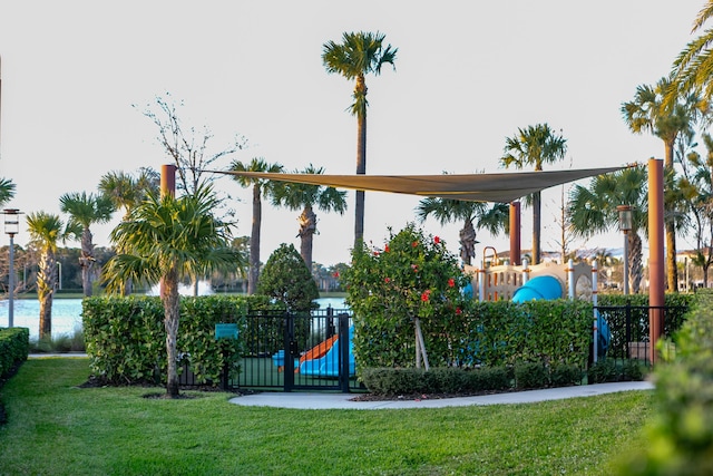 view of playground featuring a yard and a water view