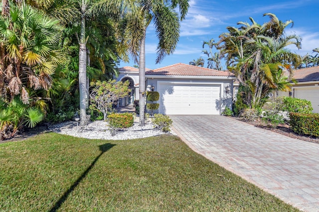 view of front of home with a garage and a front lawn