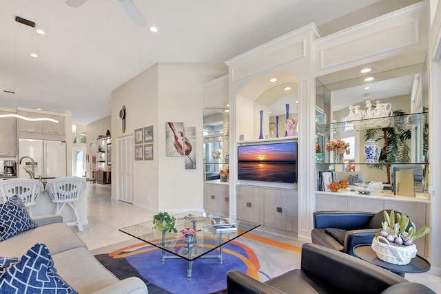 tiled living room featuring ceiling fan