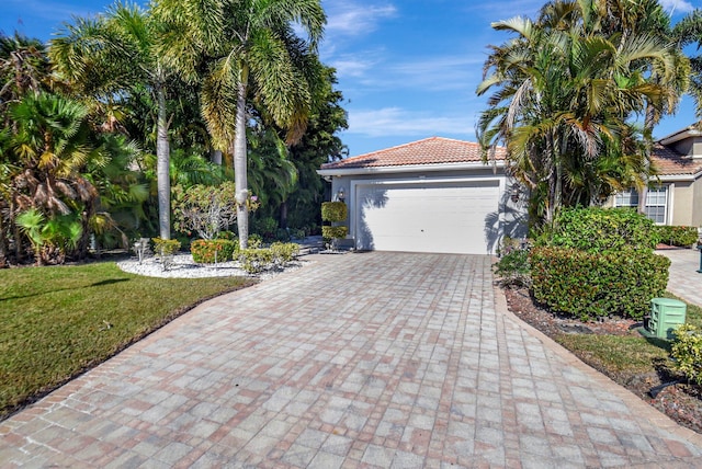 view of front of home featuring a front yard and a garage