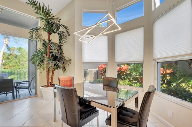 dining space with light tile patterned flooring and lofted ceiling