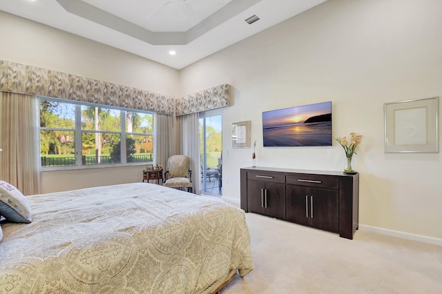 bedroom featuring access to outside, a raised ceiling, ceiling fan, and light colored carpet