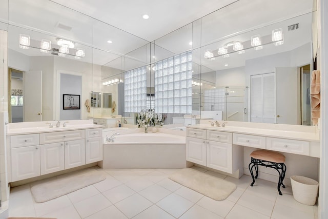 bathroom with tile patterned floors, vanity, and plus walk in shower