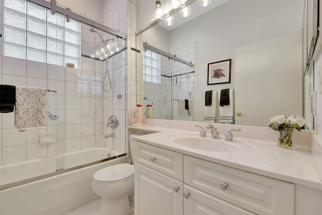 full bathroom with vanity, toilet, and shower / bath combination with glass door