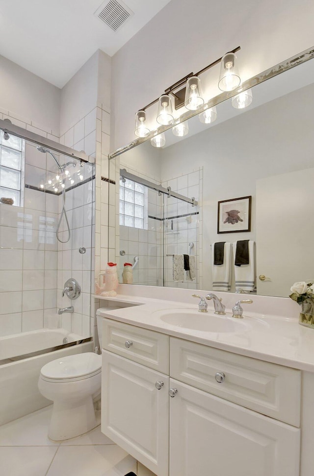 full bathroom featuring tile patterned floors, vanity, bath / shower combo with glass door, and toilet