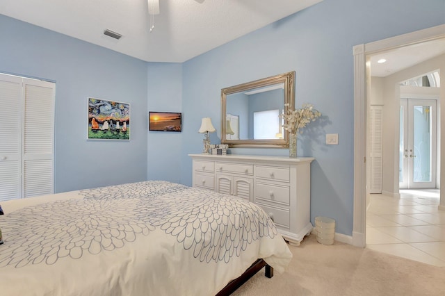 bedroom featuring ceiling fan, multiple windows, light carpet, and a closet