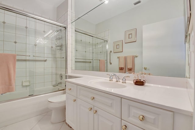 full bathroom featuring tile patterned flooring, vanity, toilet, and bath / shower combo with glass door