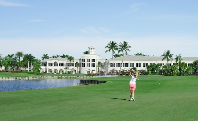 view of community with a yard and a water view