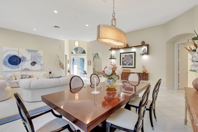 dining area with french doors and light tile patterned floors