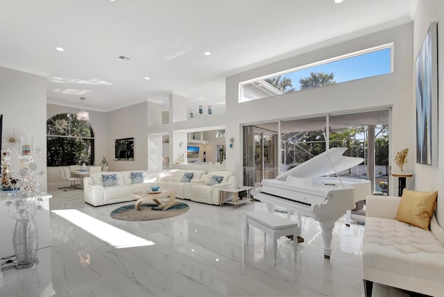 living room featuring crown molding and a high ceiling