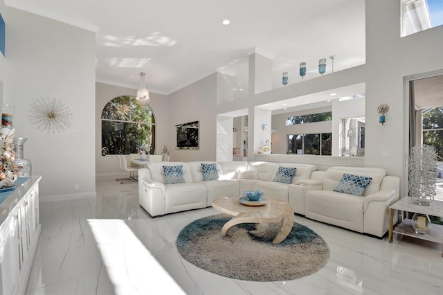 living room with crown molding and a wealth of natural light