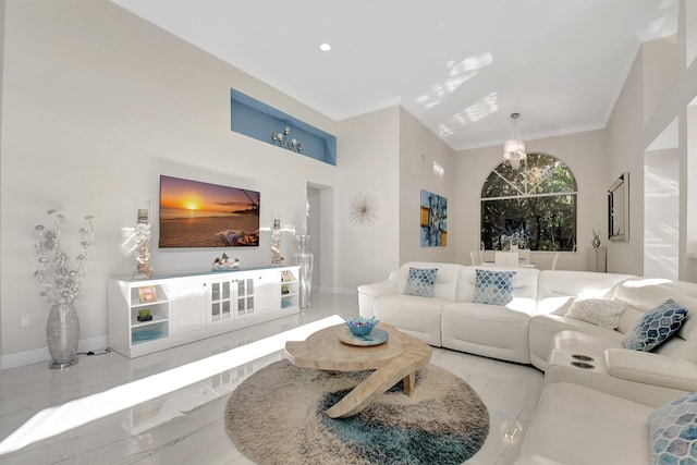 living room with crown molding and a chandelier