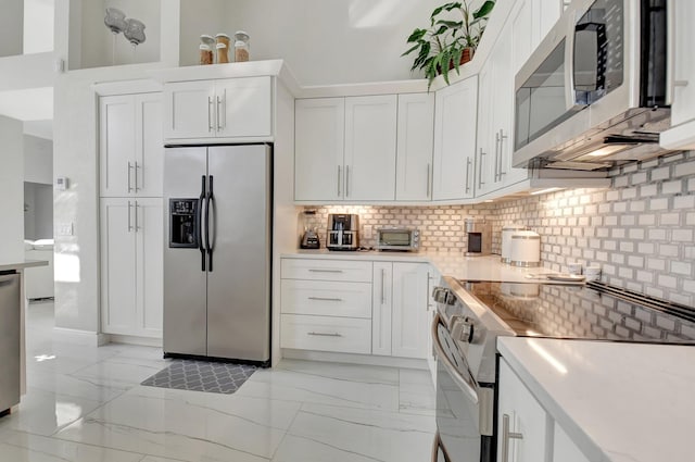 kitchen featuring backsplash, white cabinetry, and stainless steel appliances