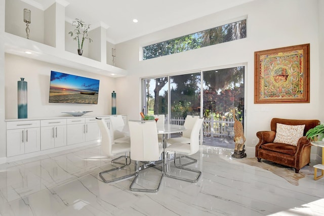 dining room featuring a towering ceiling