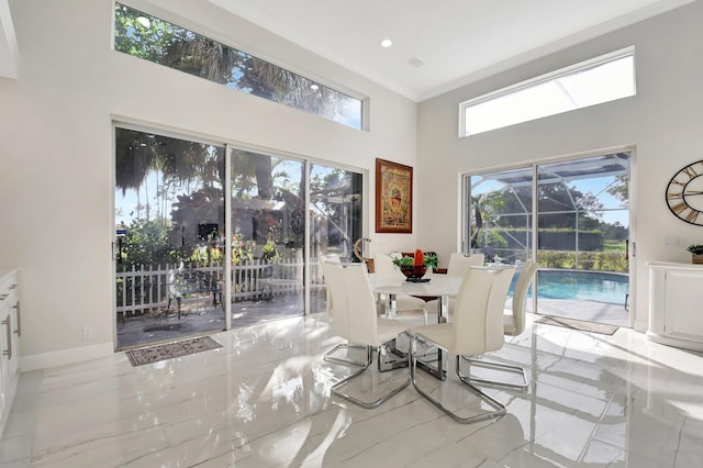 dining space with plenty of natural light and crown molding