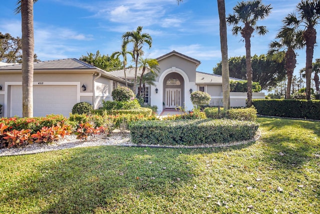 view of front facade featuring a front yard and a garage