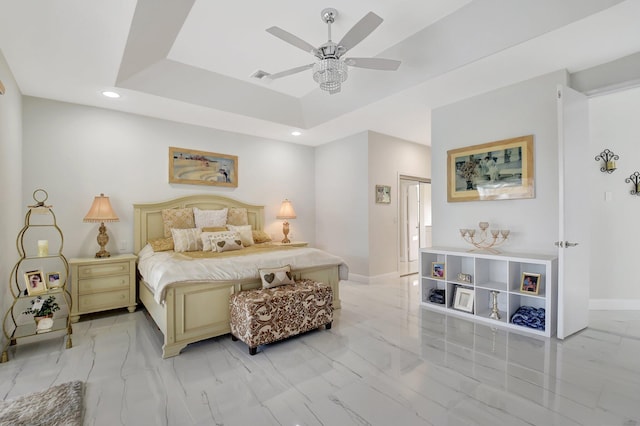 bedroom featuring a tray ceiling and ceiling fan