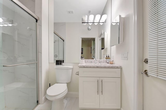 bathroom featuring vanity, toilet, and an enclosed shower