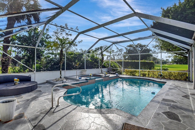 view of pool with an in ground hot tub, glass enclosure, and a patio area