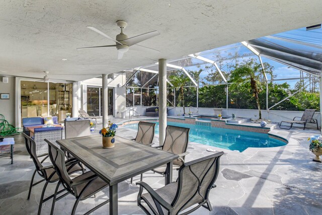 view of pool with an outdoor hangout area, glass enclosure, and a patio area