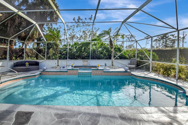 view of pool featuring glass enclosure and a jacuzzi