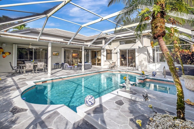 view of pool with outdoor lounge area, a patio area, and a lanai