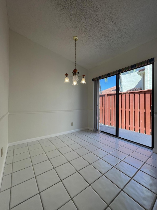 unfurnished room featuring light tile patterned flooring, vaulted ceiling, a textured ceiling, and a chandelier